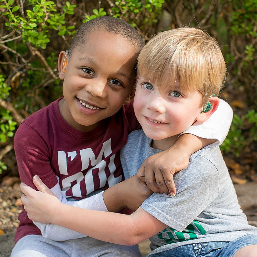 A Young Boy Holding A Baby